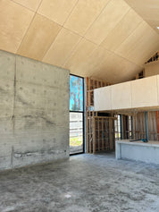 Shed House under construction interior with concrete walls and wooden ceiling